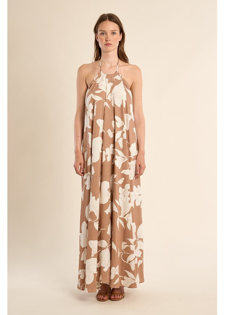 Woman wearing a floral dress on a beige background