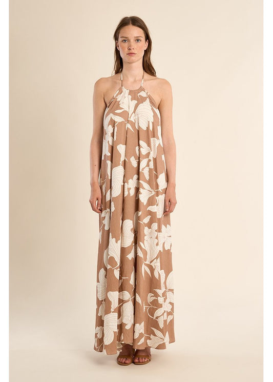 Woman wearing a floral dress on a beige background