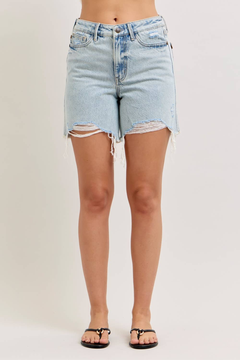 Light blue denim shorts with frayed hems on a plain background