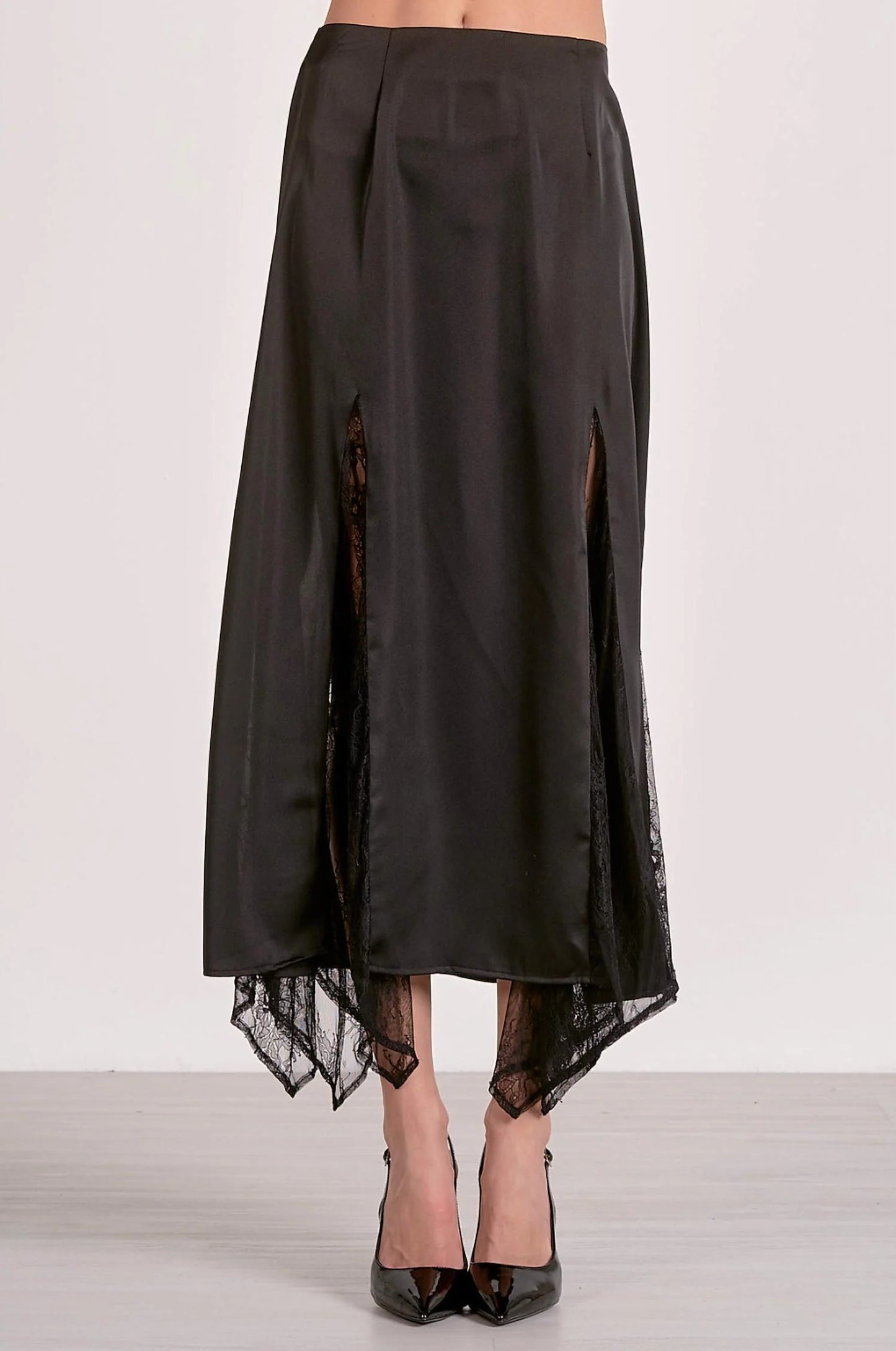 Black satin skirt with sheer lace trim on a white background
